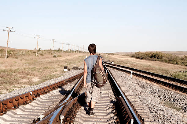 istock Teen boy with problems walking on rail road 176865090