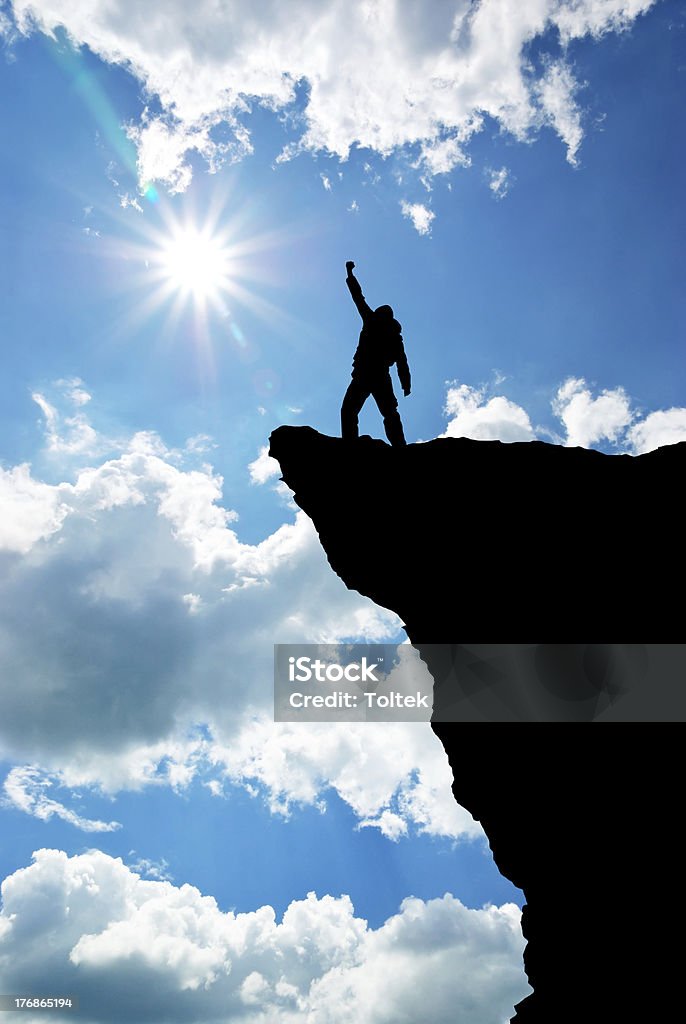 Man on top Man on top of mountain. Conceptual design.  Hiking Stock Photo