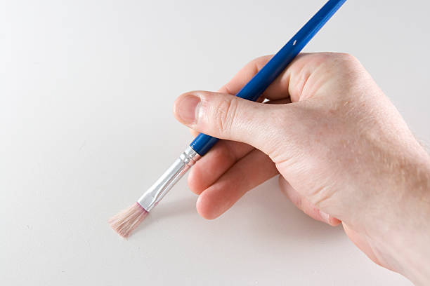 istock Man holding artists paintbrush 176865783