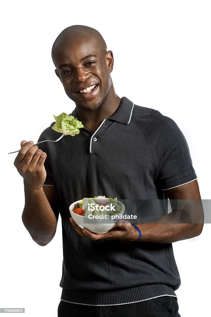 Man With Salad An attractive man eating a salad against white background 20-29 Years Stock Photo