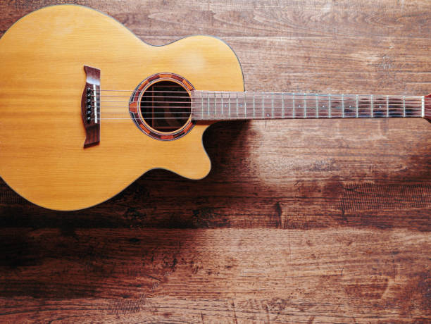 istock classical guitar on wooden background 1768658250
