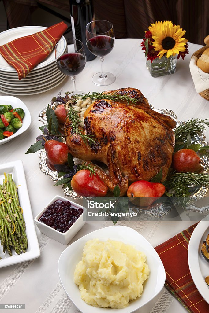 Harvest feast Delicious roasted turkey with savory vegetable side dishes in a fall theme Stuffed Turkey Stock Photo