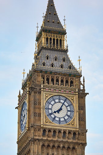 Big Ben tower clockface on Great Clock of Westminster parliament houses, closeup detail to gothic decoration. It was completed in 1859. Hands painted original Prussian blue after reconstruction.