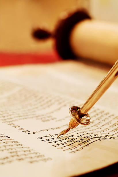 Reading the Torah Scroll "Torah scroll with a pointer, called a yad. Scroll is opened to Exodus 20, the 10 commandments." simchat torah photos stock pictures, royalty-free photos & images