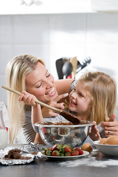 istock mother and daughter having fun in the kitchen 176866845