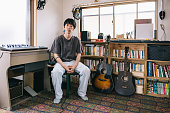 Portrait of Young Japanese musician in his home studio corner