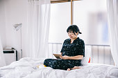 Young Japanese woman writing her pregnancy diary