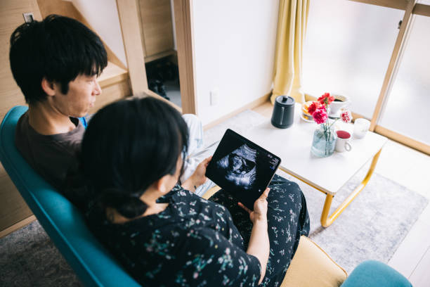 istock Couple looking at ultrasound video from a digital tablet 1768671664