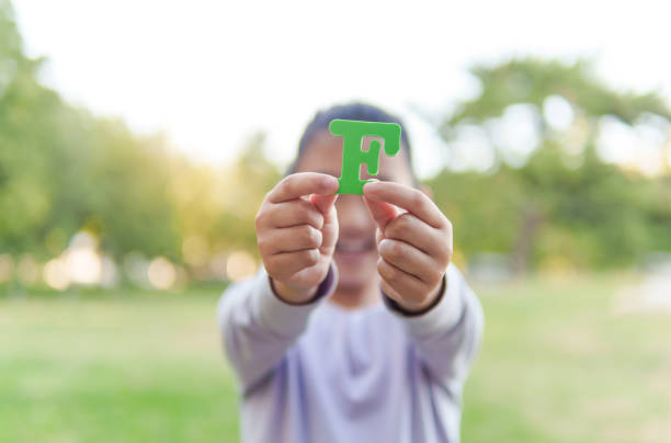istock Child Holding Letter 