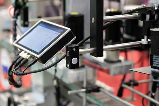 Modern production line with HMI touch screen controller. Selective focus.