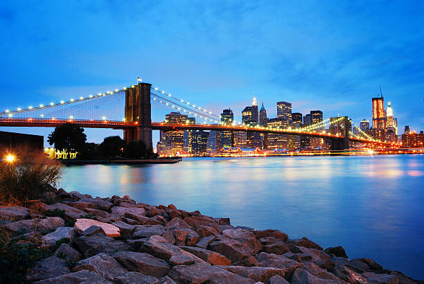 Brooklyn Bridge and Manhattan skyline in New York City Brooklyn Bridge and Manhattan skyline in New York City over Hudson River at night. brooklyn bridge new york stock pictures, royalty-free photos & images