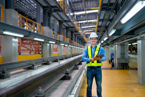 istock Portrait of professional engineer worker hold tablet and look at camera with smiling also stand near railroad tracks in factory workplace. 1768690348