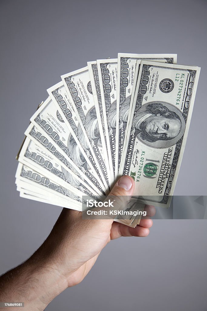 Holding Hundreds A hand full of hundreds of dollars. American One Hundred Dollar Bill Stock Photo