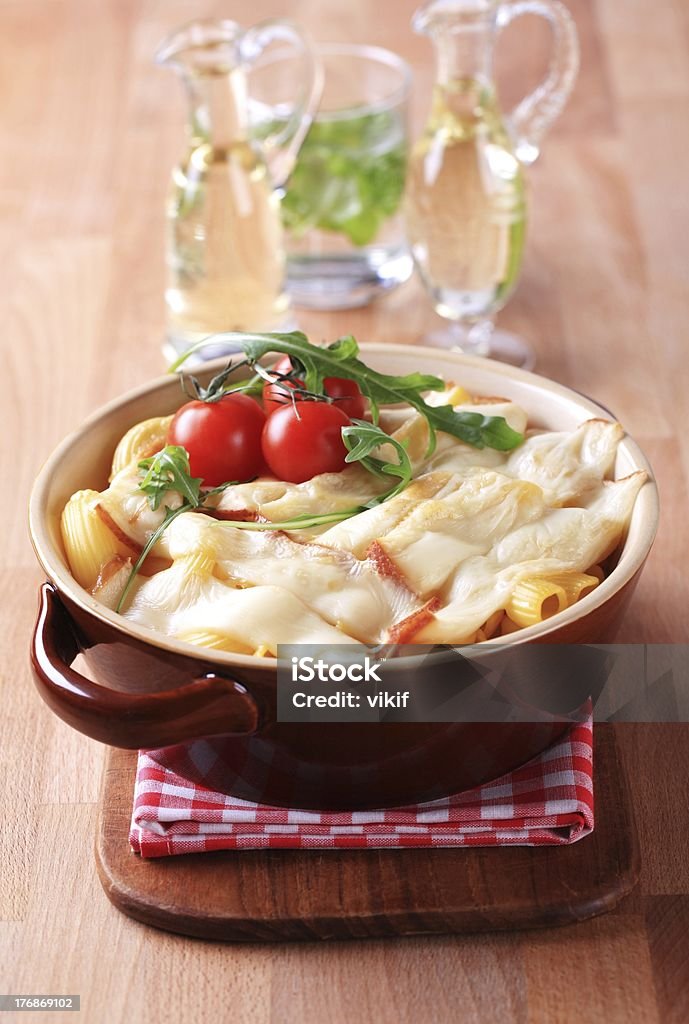 Macaroni and cheese Macaroni topped with smoked cheese in a baking dish Arugula Stock Photo