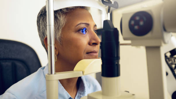 istock Eye test, machine and a woman for an optometry problem, scanning retina or surgery at a clinic. Healthcare, ophthalmology and a patient or person with an exam for vision, glasses or lens check 1768692518