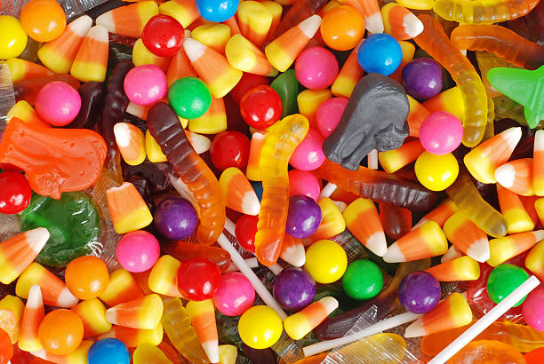mixed halloween candy background macro mixed halloween candy background halloween treats stock pictures, royalty-free photos & images