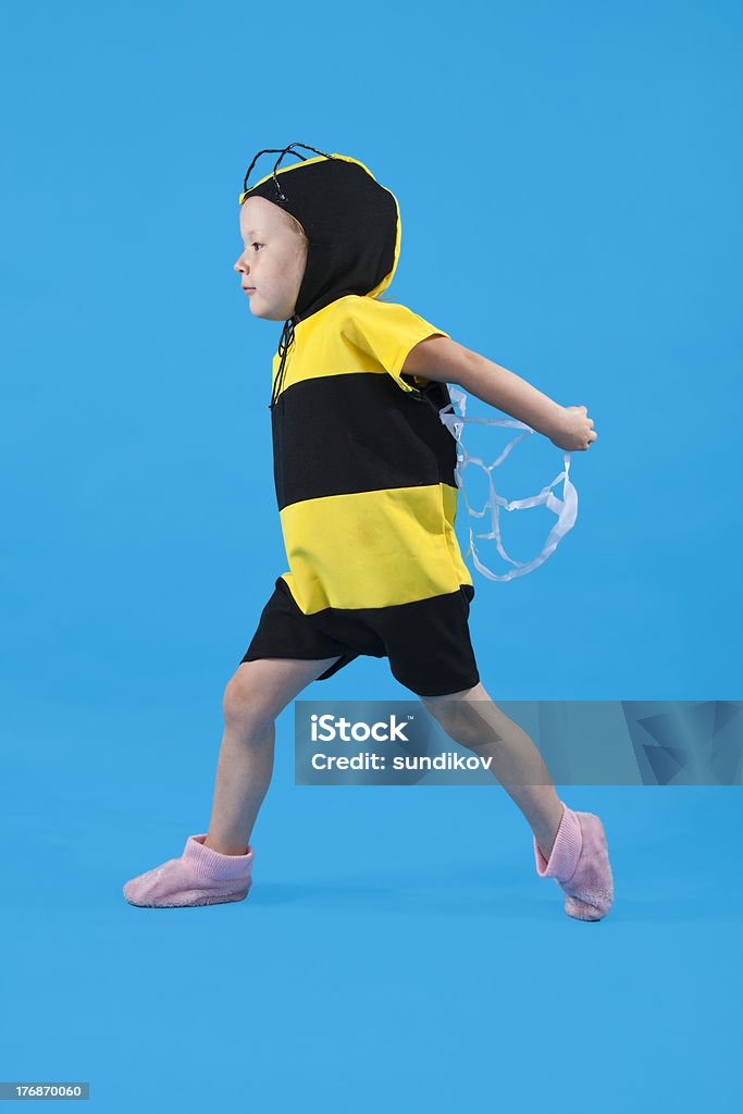 Small girl is dressed at bee costume Small girl is dressed at bee costume on blue background 4-5 Years Stock Photo