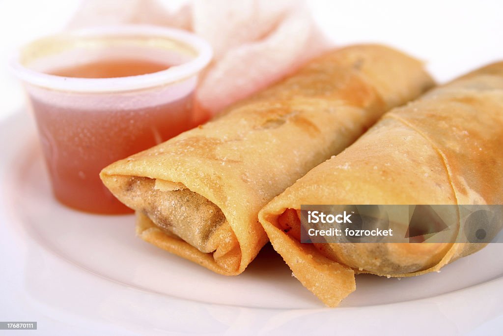 Spring rolls and dipping sauce Two meat and vegetable springs rolls with sweet and sour dipping sauce and a prawn cracker Afternoon Tea Stock Photo