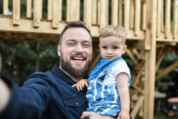 istock Smiling Father Taking Selfie With Confused Baby Boy 1768708291