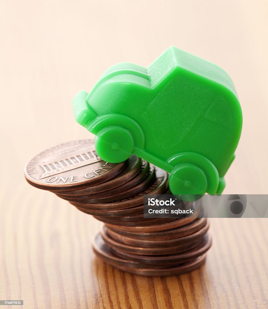 Green car miniature over pennies Brown Stock Photo