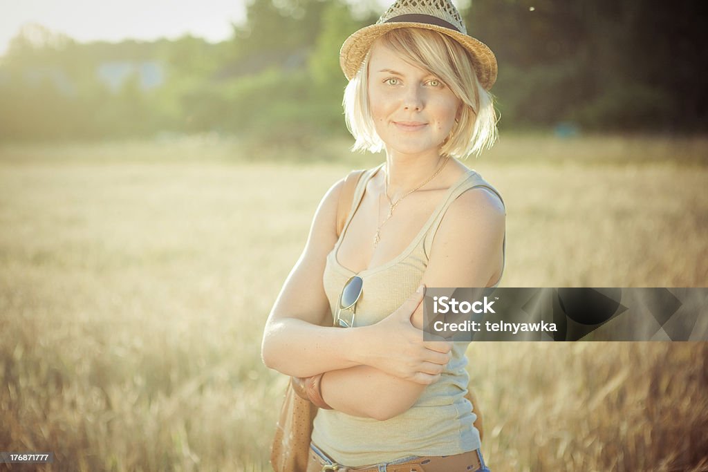 young woman on wheat field Image of young woman on wheat field Adult Stock Photo