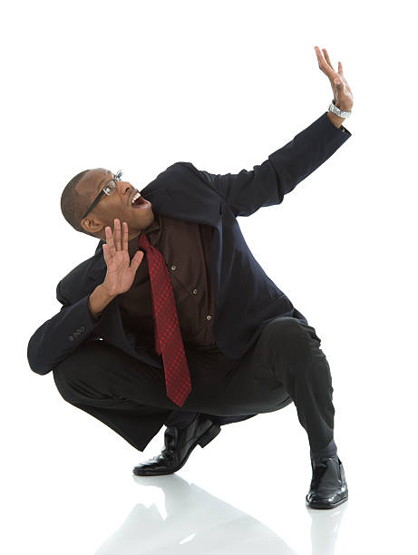 istock Crouching Black Business Man Cowering in Fear 176871946
