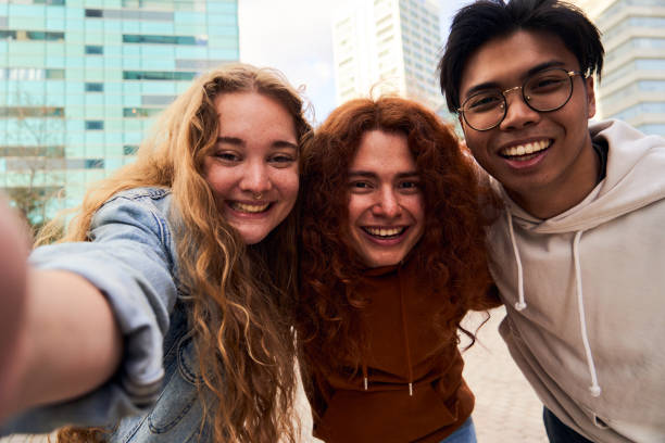 istock Group of student friends having fun outdoors taking a selfie looking at camera smiling. 1768723509