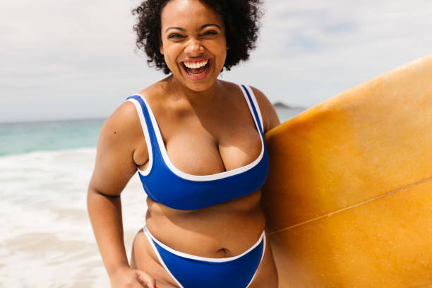 istock Adventurous female surfer having fun at the beach in summer 1768724665