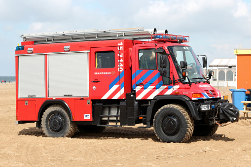 Scheveningen, Netherlands - August 6, 2012: Dutch fire engine Mercedes-Benz Unimog on the beach