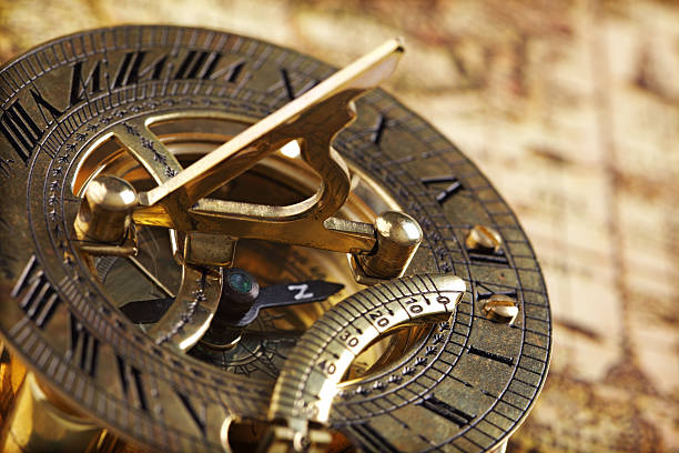bússola de bronze antigo e relógio de sol - compass direction antique guidance imagens e fotografias de stock
