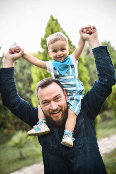 istock Crazy Ride On Father's Shoulders For Excited Toddler Boy 1768730252
