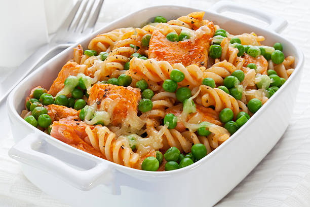 Pasta Bake with Salmon and Peas "A baked dish of fusili or spiral pasta, with grilled salmon, peas and mozzarella. For more of my pasta images, please click" pasta casserole stock pictures, royalty-free photos & images