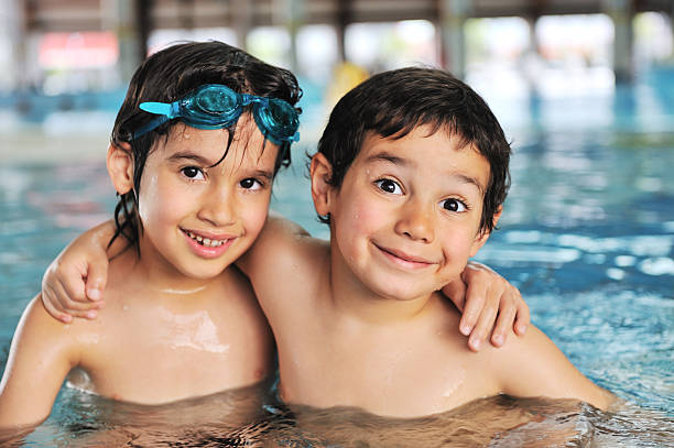 Summertime and swimming activities for happy children on the pool stock photo