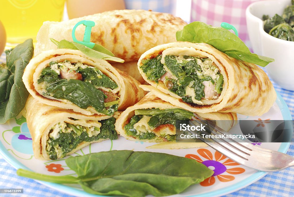 pancakes with spinach and eggs "plate of rolled  pancakes stuffed with spinach ,bacon and eggs" Rolled Up Stock Photo