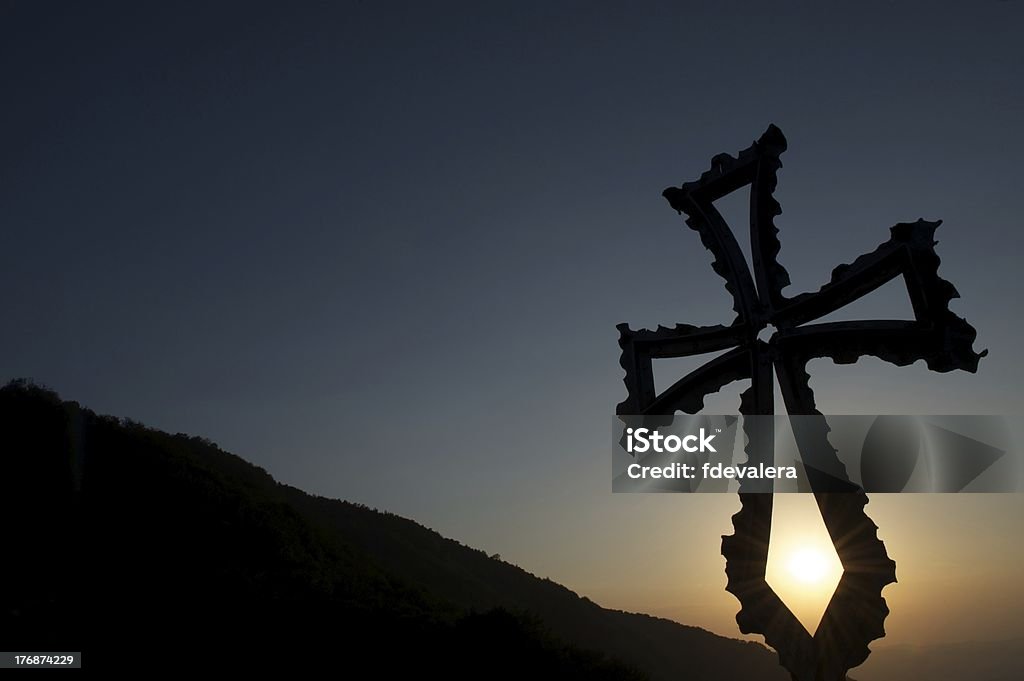 Christian cross au coucher du soleil avec les montagnes en toile de fond - Photo de Croix religieuse libre de droits