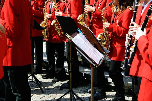 Young musicians performing in the streets of a city on a bright day of weekend