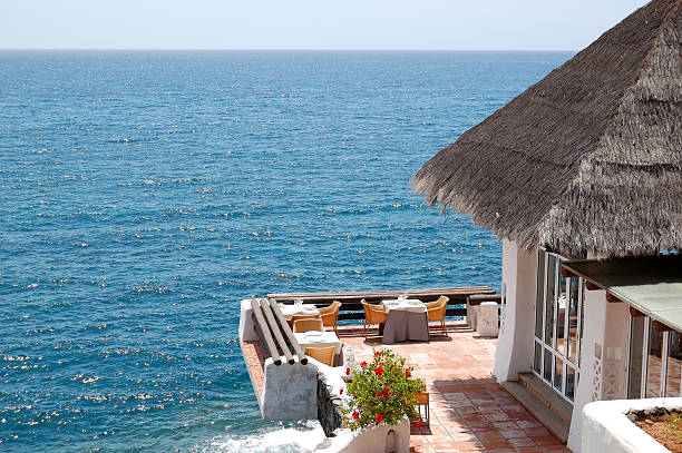 istock Open-air restaurant with view on Atlantic Ocean, Tenerife island, Spain 176875354