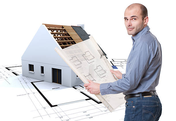istock Man with plans and house in construction 176875758