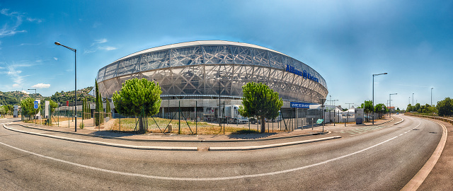 Berlin, Germany - August 30, 2014: Olympiastadion under blue sky with cumulus clouds on sunny summer day. No people, low angle view. Built: 1934-1936. Architects: Werner March, Albert Speer.