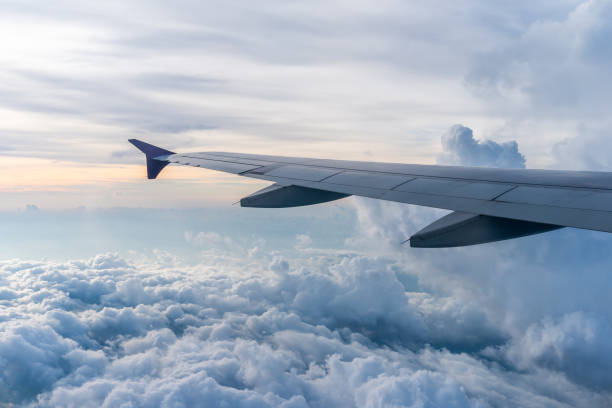 istock Airplane wings in the sky with many clouds during the day 1768760271