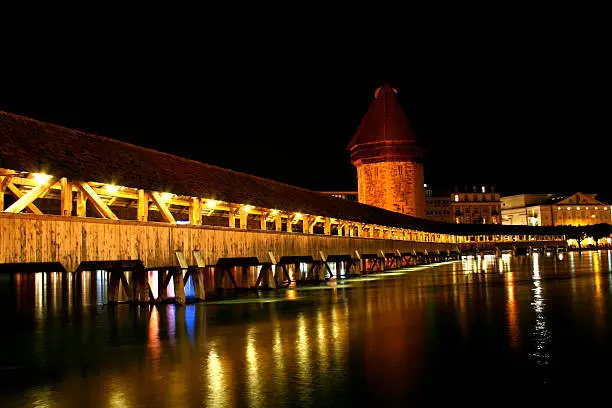 "Digital photo of the famous chapel-bridge in Lucerne in switzerland by night. The bridge was build in the year 1365, it is the oldest and longest (204 m) bridge with a roof in europe."