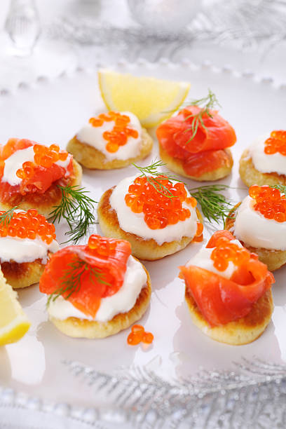 istock Holiday appetizer with caviar and salmon on white plate, 176876552