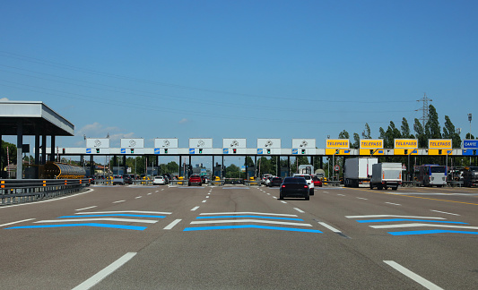 Mestre, VE, Italy - July 8, 2022: lanes and the motorway toll booth for toll payment and more cars