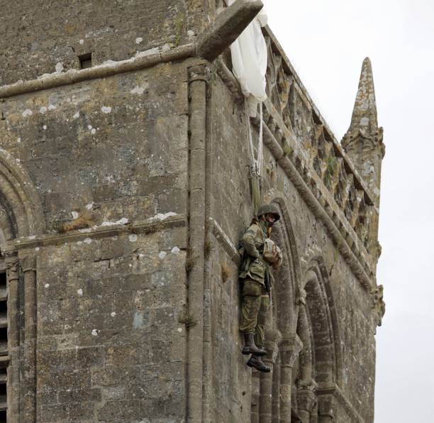 Sainte-Mere-Eglise, FRA, France - August 21, 2022: DDAY Memorial with American Paratrooper on the bell tower