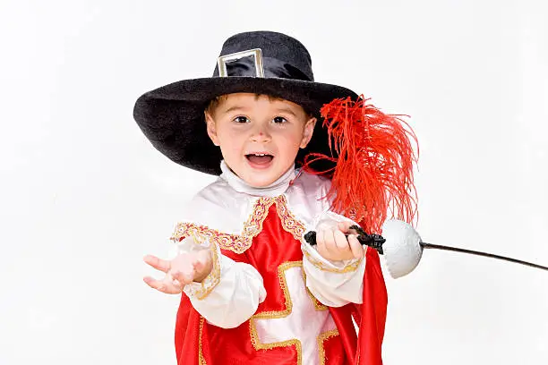 Boy with carnival costume . Little fighting musketeer.