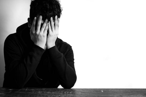 istock depressed man on black and white background 1768775620
