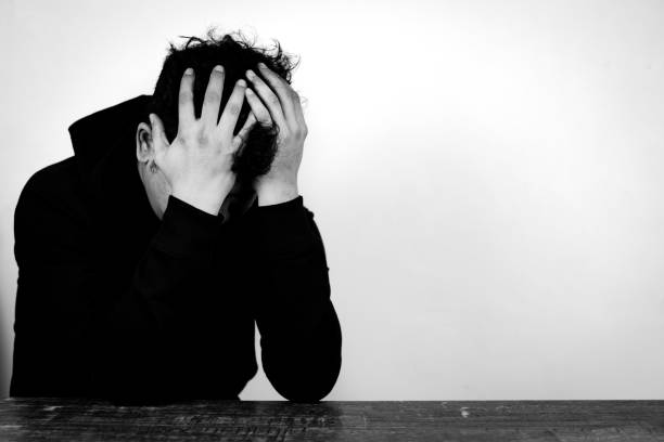 istock depressed man on black and white background 1768776140