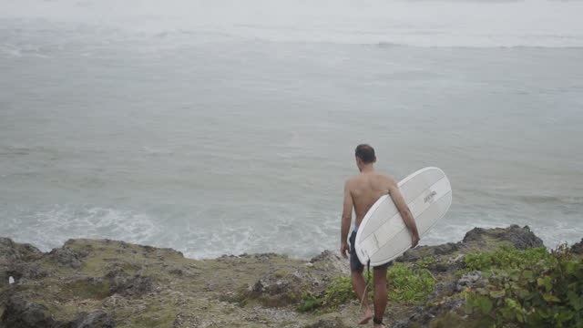 Mid adult man going for a surf in Okinawa