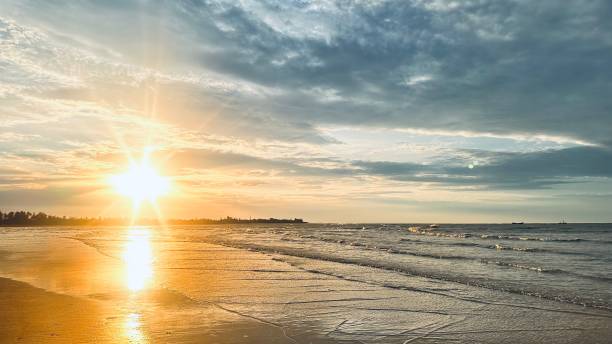 istock a surfer walks along the shoreline with a surfboard at sunset 1768780946