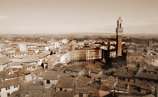 civic tower called Torre del Mangia and panorama of the city of Siena in Tuscany in Central Italy with sepia Toned